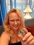Holding a colorful swirled marble representing layers of healing and old feelings